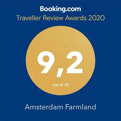 a sign that reads travel review awards in a yellow circle at Amsterdam Farmland in Amsterdam