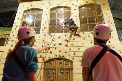 three people in helmets on a climbing wall at Hotel Eemhof by Center Parcs in Zeewolde