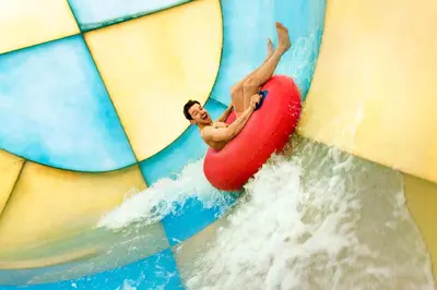 a man on a raft in a wave pool at Hotel Eemhof by Center Parcs in Zeewolde