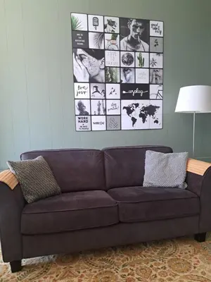 a couch in a living room with a picture on the wall at Middelpunt Opmeer in Opmeer
