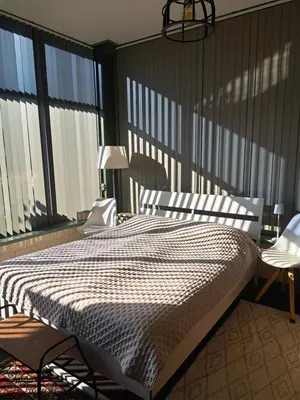 a bedroom with a bed in a room with windows at Middelpunt Opmeer in Opmeer