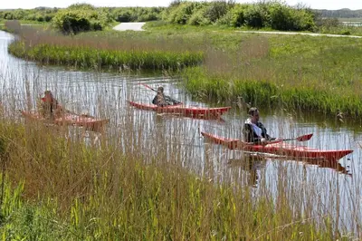 three people in kayaks in a body of water at Middelpunt Opmeer in Opmeer