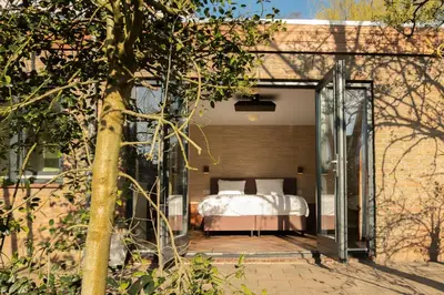 a bedroom with a bed on a patio at Kwadijkerbos in Kwadijk