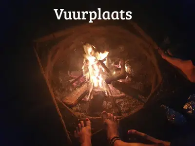 a group of people sitting around a fire at Kwadijkerbos in Kwadijk