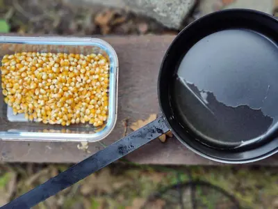 a pan filled with corn next to a magnifying glass at Kwadijkerbos in Kwadijk