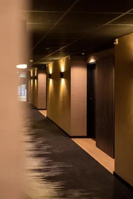 a hallway of an office building with a long corridor at Hotel Lowietje Lisse - Keukenhof - Free Parking in Lisse