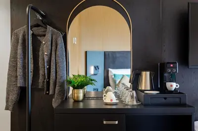 a dressing room with a counter with a mirror at Hotel Lowietje Lisse - Keukenhof - Free Parking in Lisse
