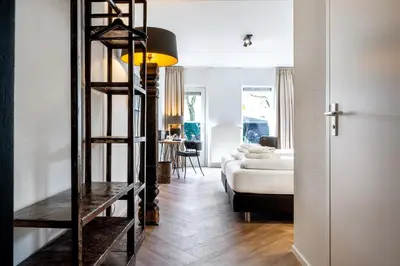 a room with a ladder leading to a bedroom at Broeck Oudewater in Oudewater