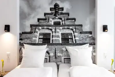 a bedroom with a wall mural of a building at Broeck Oudewater in Oudewater
