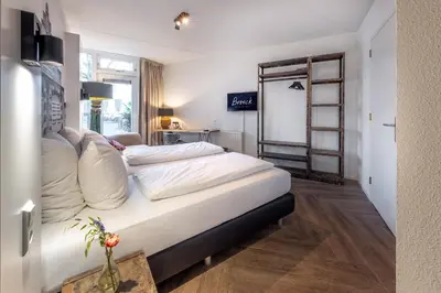 a bedroom with a bed with white pillows on it at Broeck Oudewater in Oudewater