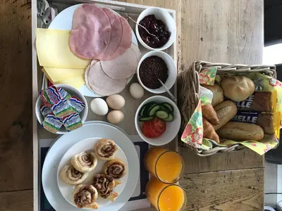 a table topped with plates of food and other foods at Flowerbed in Voorhout