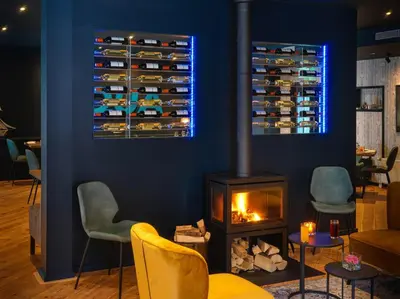 a living room with a fireplace and a blue wall at Appartement Aqua in Oude Wetering