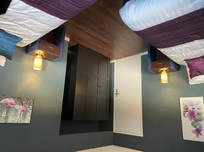 a room with a bed and a cabinet and lights at Appartement Aqua in Oude Wetering