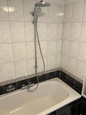 a bath tub with a shower in a bathroom at Appartement Aqua in Oude Wetering
