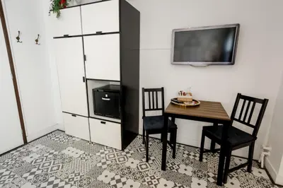 a dining room with a table and chairs and a tv at Aris Amsterdam in Amsterdam