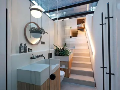 a bathroom with a sink and a staircase at vondice hotel in Amsterdam
