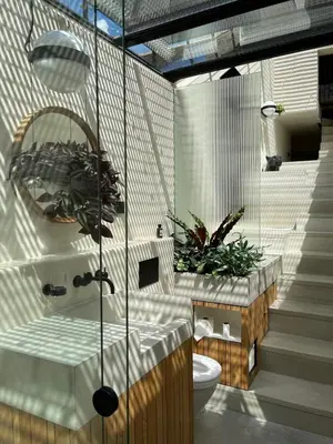 a bathroom with a toilet and plants in it at vondice hotel in Amsterdam