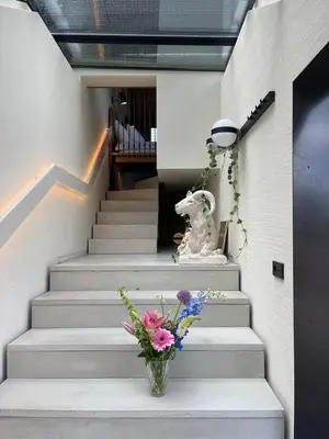 a vase of flowers sitting on the stairs of a building at vondice hotel in Amsterdam