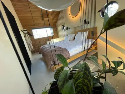 a bedroom with a bed and a potted plant at vondice hotel in Amsterdam