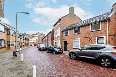 a street with cars parked on a brick road at Kusthuiskatwijk in Katwijk aan Zee