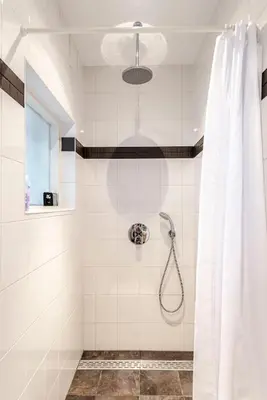 a bathroom with a shower with a shower curtain at Kusthuiskatwijk in Katwijk aan Zee