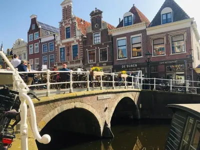 a bridge over a canal in a city with buildings at Millsight in Uitgeest