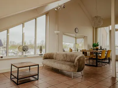 a living room with a couch and a table at Apartment Penthouse by Interhome in Uitgeest