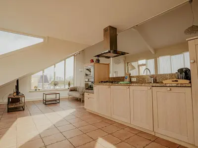 a large kitchen with a large window in a room at Apartment Penthouse by Interhome in Uitgeest