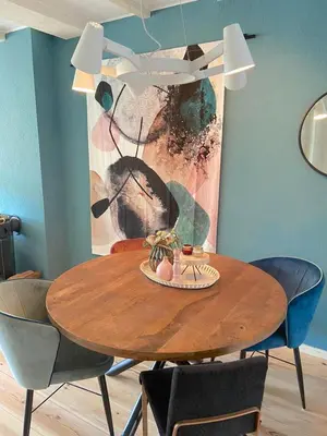 a dining room with a wooden table and chairs at Fijne vakantiehuizen 50 mtr van het strand in Egmond aan Zee