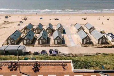 a row of houses on the beach next to the beach at Thalassa Beach Houses in Zandvoort