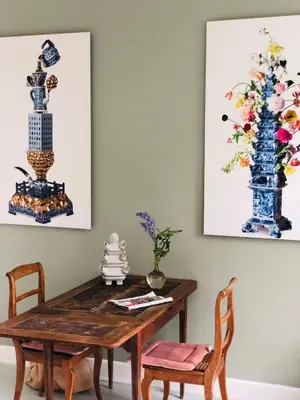 a dining room with a wooden table and two vases at HOMESTEAD Amsterdam in Amsterdam
