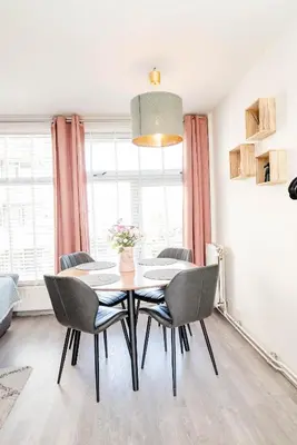 a dining room with a table and chairs at Amsterdam Beach Apartment 44 in Zandvoort