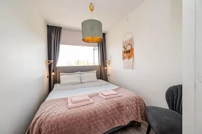 a bedroom with a bed with two towels on it at Amsterdam Beach Apartment 44 in Zandvoort