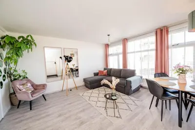 a living room with a couch and a table at Amsterdam Beach Apartment 44 in Zandvoort