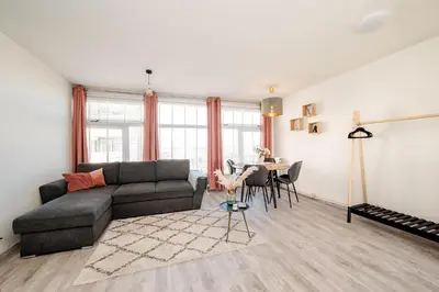 a living room with a couch and a table at Amsterdam Beach Apartment 44 in Zandvoort