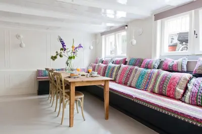 a living room with a long couch with a table at Luna's Hideaway in Amsterdam