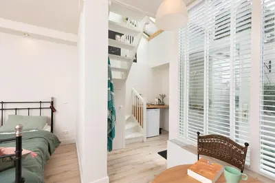 a bedroom with a bed and a desk in a room at Boutique Studio Magielsen in Amsterdam