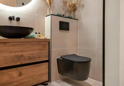 a bathroom with a black toilet and a sink at Boutique Studio Magielsen in Amsterdam