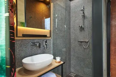 a bathroom with a sink and a shower at Inntel Hotels Amsterdam Landmark in Amsterdam