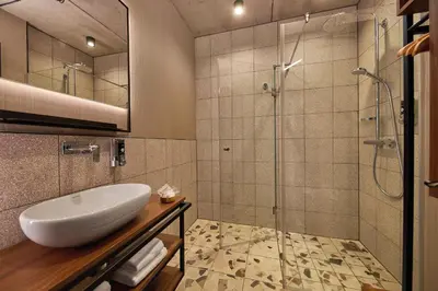 a bathroom with a sink and a shower at Inntel Hotels Amsterdam Landmark in Amsterdam