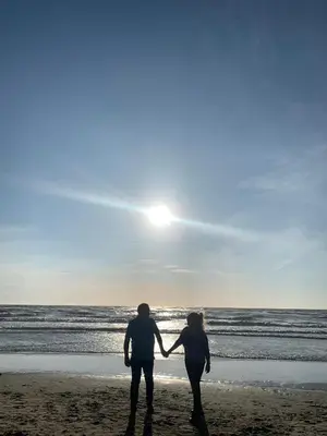 two people standing on the beach holding hands at Cottage 44 - Free parking! in Zandvoort