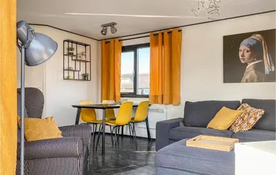 a living room with a couch and a table at Lake Front Home In Breukelen in Breukelen