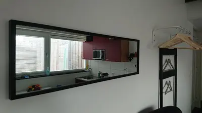 a mirror hanging on a wall in a kitchen at Goody in Zandvoort