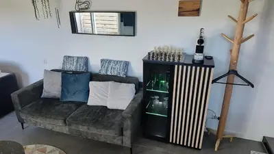 a living room with a couch and a chair at Goody in Zandvoort