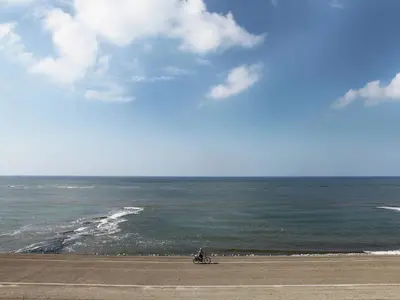 a person riding a motorcycle on a beach near the ocean at Modern holiday home near Schoorl and beach in Schoorldam
