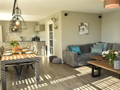 a living room with a couch and a table at Modern holiday home near Schoorl and beach in Schoorldam