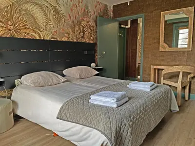 a bedroom with a bed with two towels on it at Villa Prinsenhof # Twaalf in Bergen
