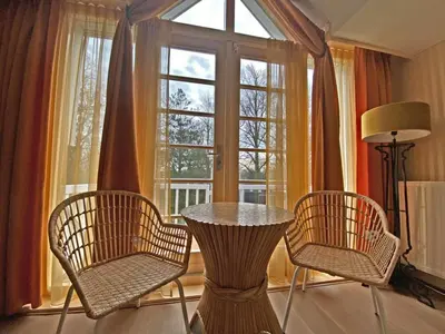 a table and chairs in a room with a window at Villa Prinsenhof # Vierentwintig in Bergen