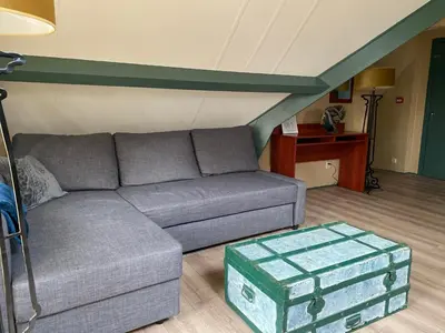 a living room with a couch and a table at Villa Prinsenhof # Zes in Bergen