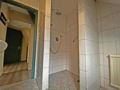 a bathroom with a shower with a mirror at Villa Prinsenhof # Zes in Bergen